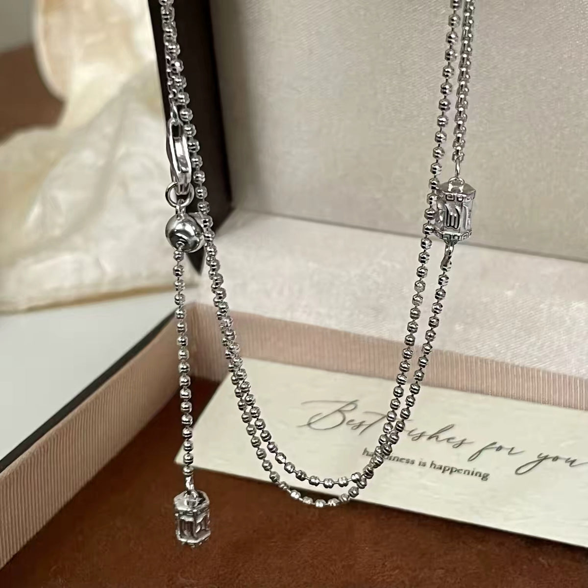 Fashion jewelry: silver ball-chain necklace with a clear cube charm in a gift box