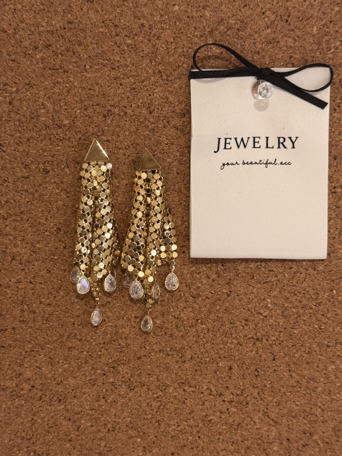 Gold-tone dangle earrings with sequin tassels and clear teardrop crystals.